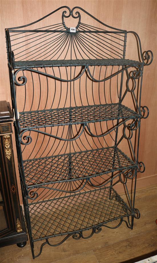 A wrought iron four tier bakers rack